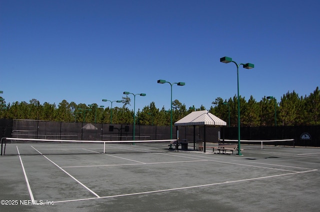 view of sport court with fence