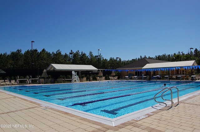 pool featuring fence and a patio area