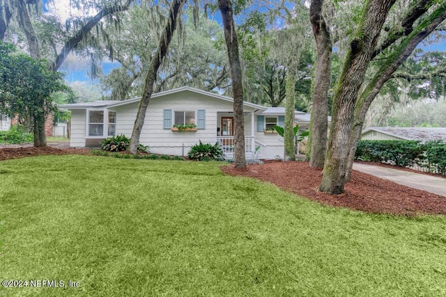 ranch-style house with driveway and a front yard