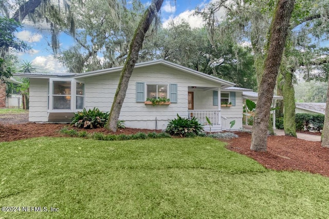 single story home with a porch and a front lawn