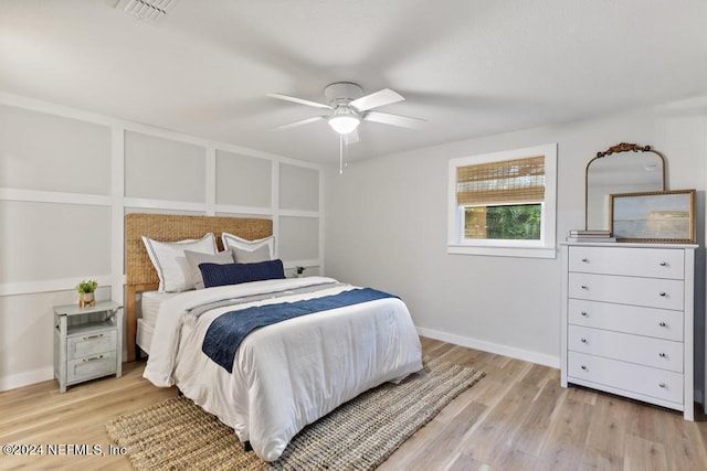 bedroom with a ceiling fan, baseboards, visible vents, and light wood-style flooring