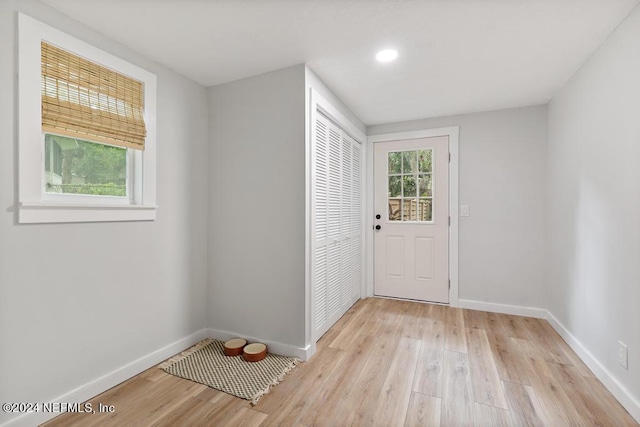 doorway with recessed lighting, baseboards, and light wood-style floors