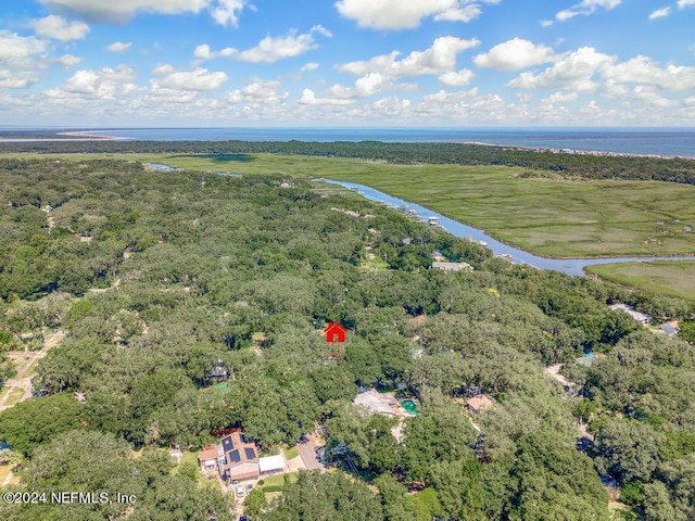 birds eye view of property featuring a water view and a wooded view