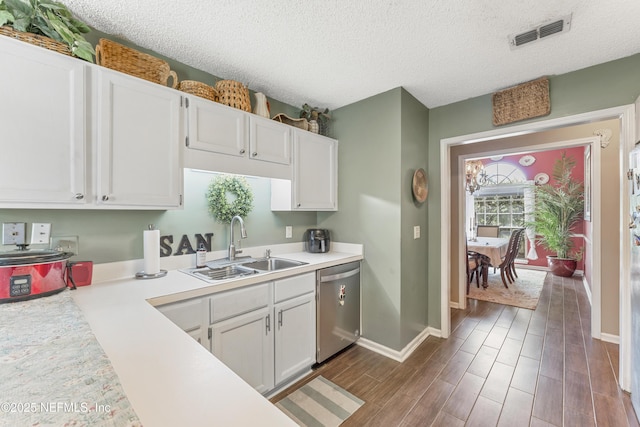 10919 Houndwell Way, Jacksonville, FL 32225 - kitchen with white cabinets, a sink, light countertops, stainless steel dishwasher, and visible vents