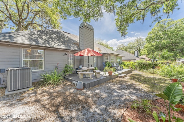 10919 Houndwell Way, Jacksonville, FL 32225 - back of house with a chimney, a deck, and cooling unit