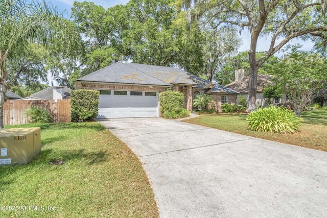 10919 Houndwell Way, Jacksonville, FL 32225 - ranch-style house with a chimney, a front yard, fence, concrete driveway, and an attached garage