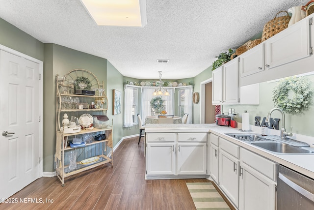 10919 Houndwell Way, Jacksonville, FL 32225 - kitchen with a sink, white cabinetry, a peninsula, and dishwasher
