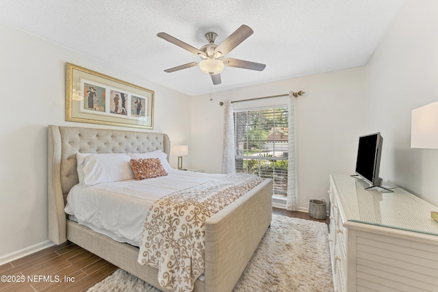 10919 Houndwell Way, Jacksonville, FL 32225 - bedroom with baseboards, ceiling fan, a textured ceiling, and wood finished floors