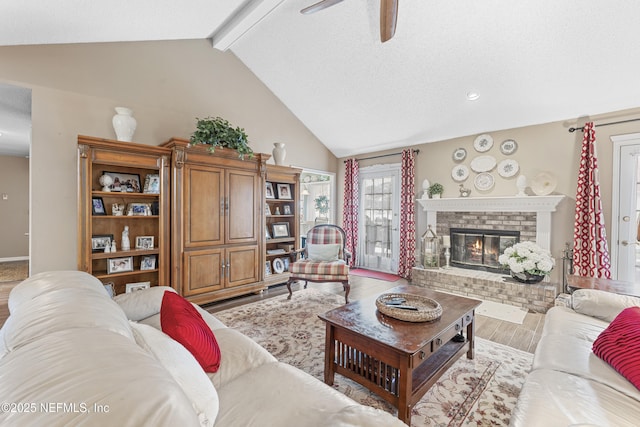 10919 Houndwell Way, Jacksonville, FL 32225 - living room with ceiling fan, a fireplace, wood finished floors, baseboards, and beamed ceiling