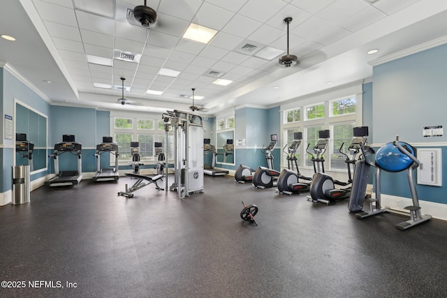workout area with baseboards, ornamental molding, a drop ceiling, and visible vents