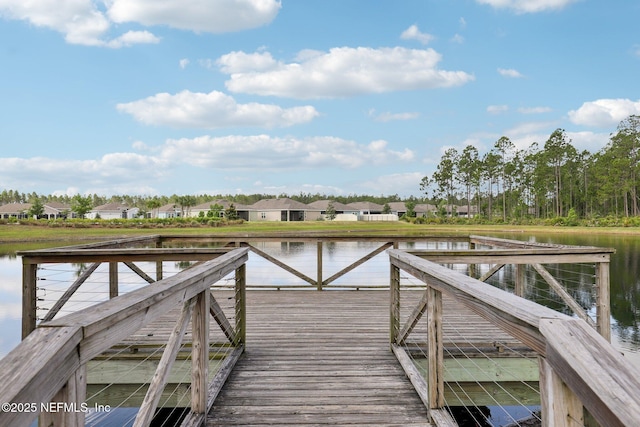 view of dock featuring a residential view and a water view
