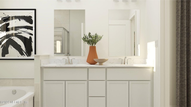 full bathroom featuring a sink, a garden tub, a stall shower, and double vanity