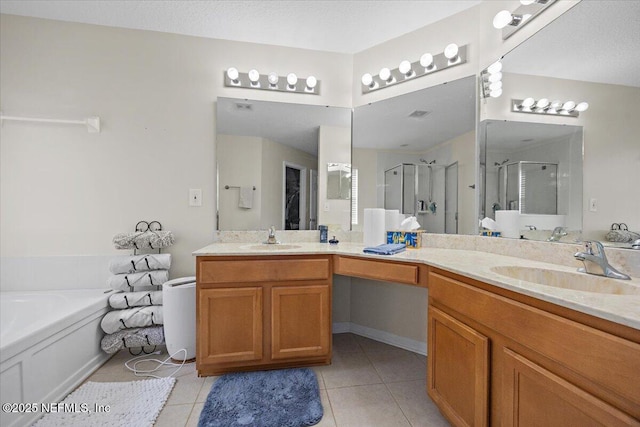 bathroom with a sink, tile patterned floors, a shower stall, and double vanity
