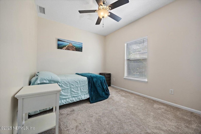 carpeted bedroom featuring a ceiling fan, baseboards, and visible vents