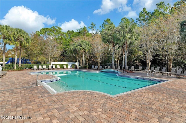pool featuring a patio and fence