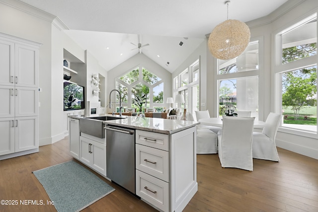 kitchen featuring a kitchen island with sink, white cabinets, hardwood / wood-style flooring, a ceiling fan, and dishwasher