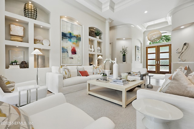 living room with decorative columns, french doors, crown molding, built in shelves, and recessed lighting
