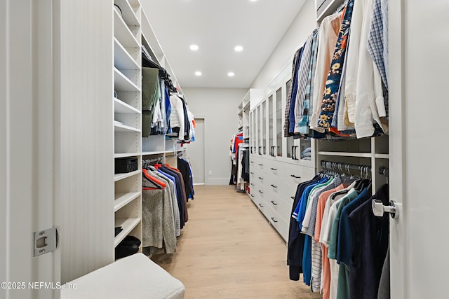 walk in closet with light wood-type flooring