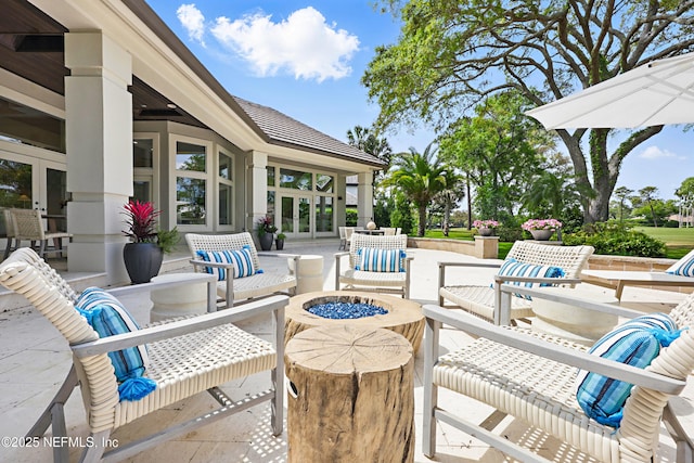 view of patio / terrace featuring a fire pit and french doors