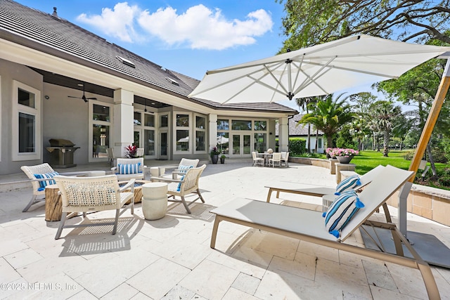 view of patio / terrace with french doors, outdoor dining space, ceiling fan, and outdoor lounge area