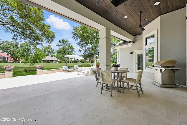 view of patio with outdoor dining space and a grill