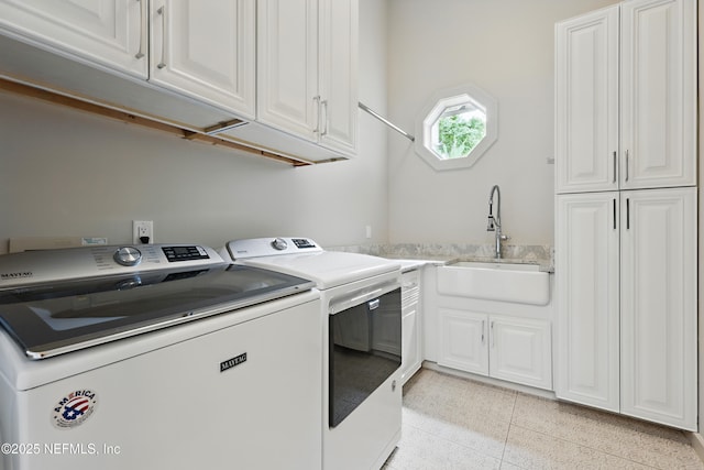 washroom with separate washer and dryer, a sink, and cabinet space