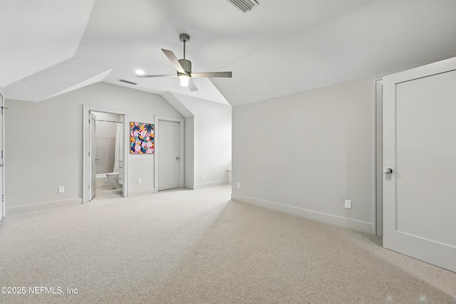 bonus room with a ceiling fan, visible vents, light carpet, and vaulted ceiling