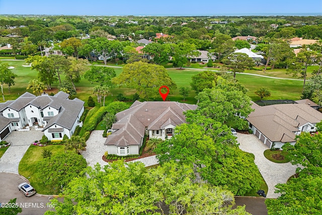 drone / aerial view with view of golf course and a residential view