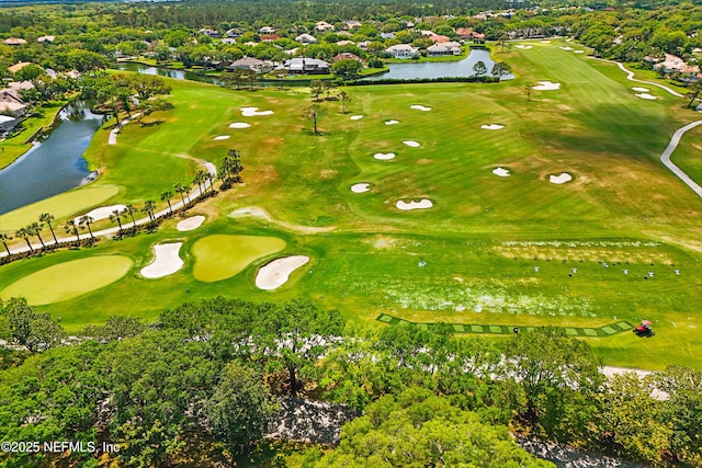 drone / aerial view with view of golf course and a water view
