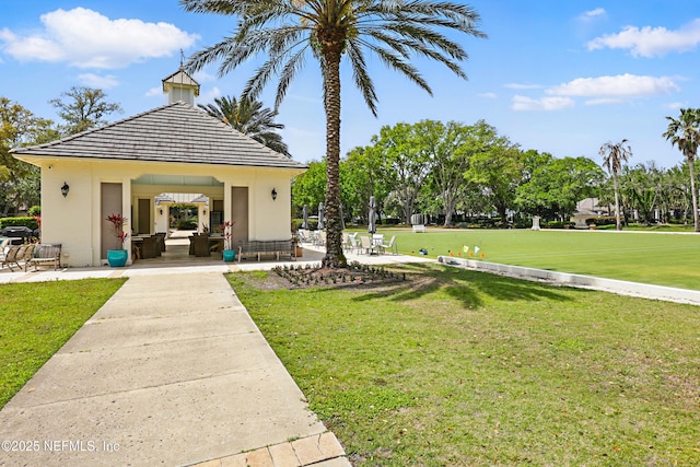 view of home's community with a yard