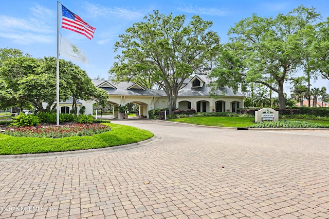 view of building exterior with curved driveway
