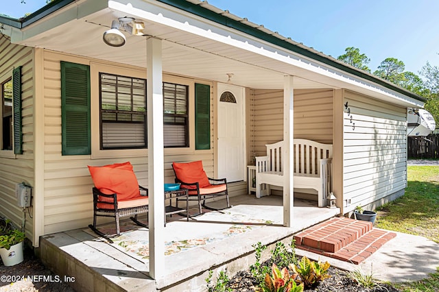 view of exterior entry with covered porch
