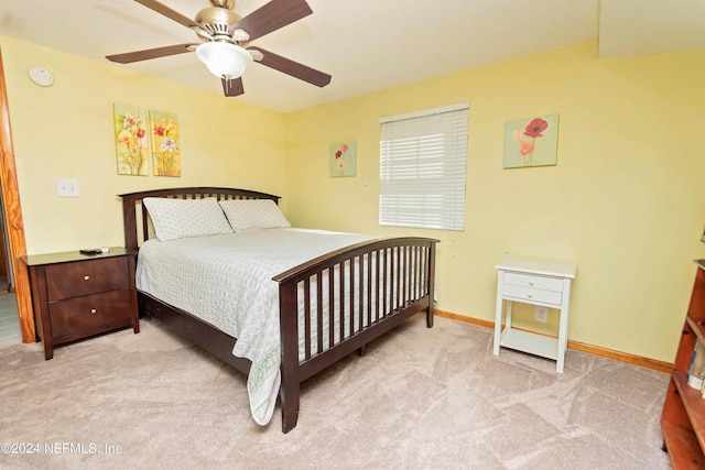 carpeted bedroom with a ceiling fan and baseboards