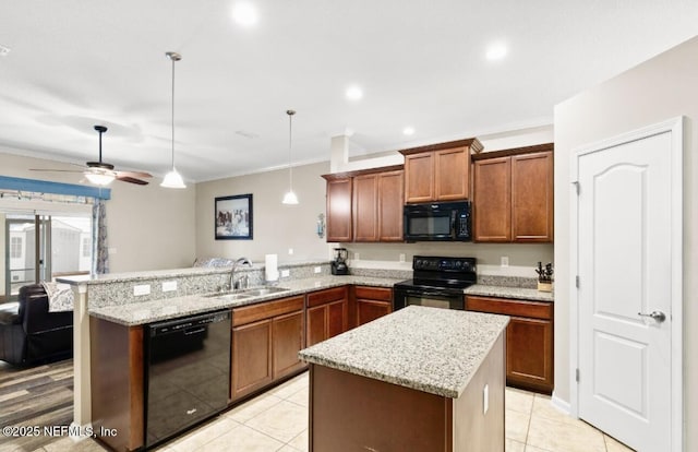 3237 Deer Creek Dr, Middleburg, FL 32068 - kitchen with black appliances, a peninsula, crown molding, light stone countertops, and pendant lighting