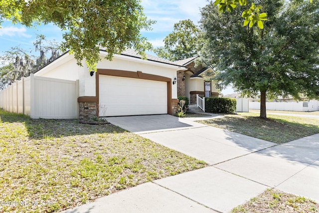 3237 Deer Creek Dr, Middleburg, FL 32068 - view of front of home featuring stone siding, an attached garage, concrete driveway, and stucco siding