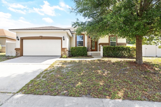 3237 Deer Creek Dr, Middleburg, FL 32068 - view of front of home with an attached garage, stucco siding, concrete driveway, stone siding, and a gate