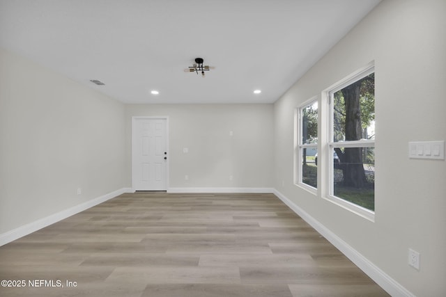 unfurnished room featuring recessed lighting, baseboards, visible vents, and light wood-style flooring