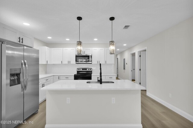 kitchen featuring light wood-style floors, a sink, white cabinetry, and stainless steel appliances