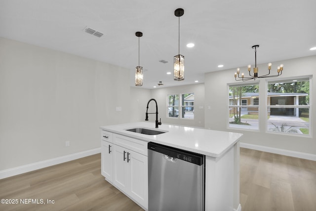 kitchen with light wood-style floors, a notable chandelier, a sink, and dishwasher