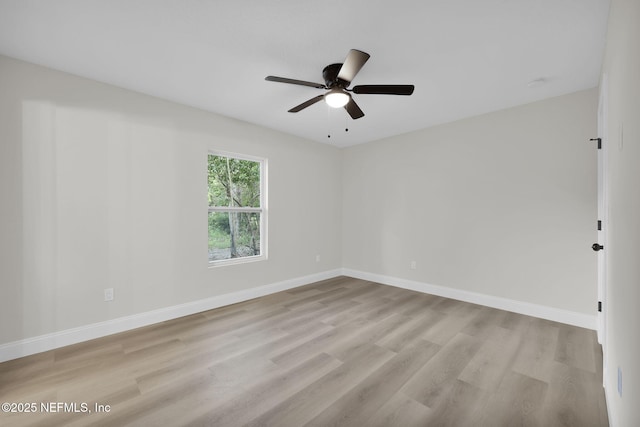 empty room with a ceiling fan, baseboards, and light wood-style floors