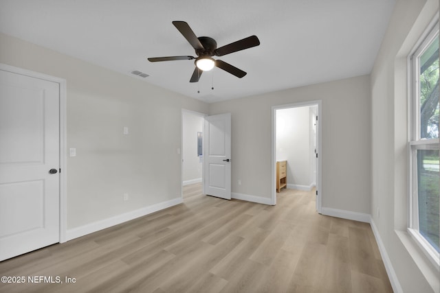unfurnished bedroom with ceiling fan, light wood-style floors, baseboards, ensuite bathroom, and visible vents
