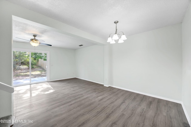 spare room with baseboards, a textured ceiling, ceiling fan with notable chandelier, and wood finished floors