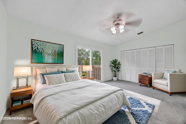 bedroom featuring visible vents, carpet, lofted ceiling, and a closet