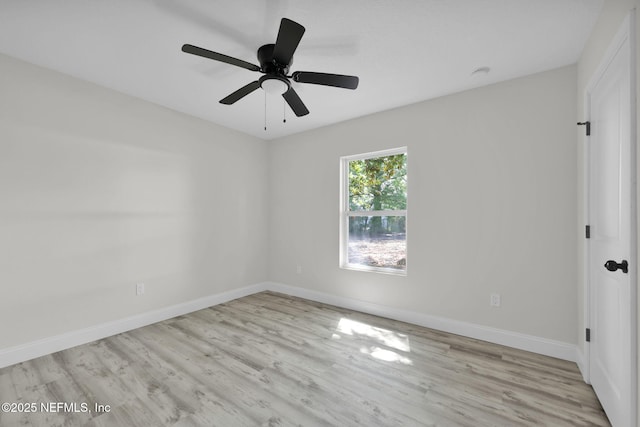 empty room featuring baseboards, a ceiling fan, and wood finished floors