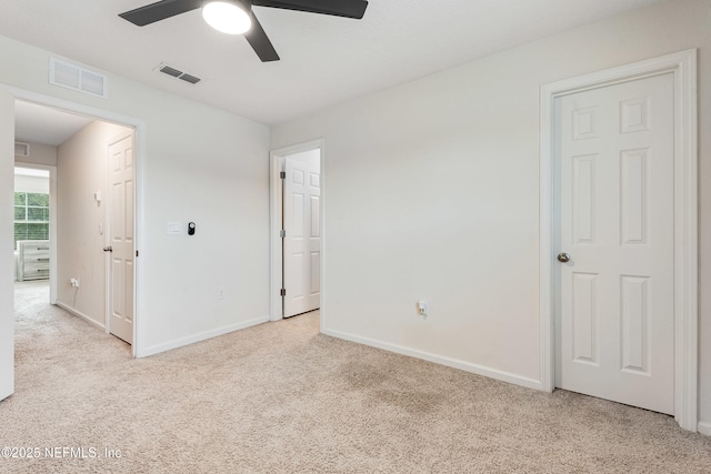 unfurnished bedroom featuring visible vents, baseboards, and light carpet