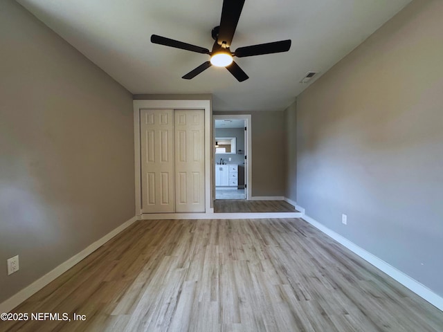 2103 W 14th St, Jacksonville, FL 32209 - unfurnished bedroom with wood finished floors, baseboards, a closet, and ceiling fan