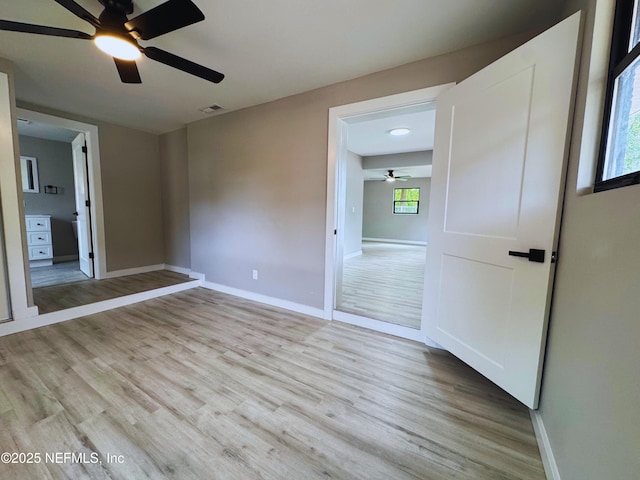 2103 W 14th St, Jacksonville, FL 32209 - unfurnished bedroom featuring light wood-type flooring, baseboards, and multiple windows