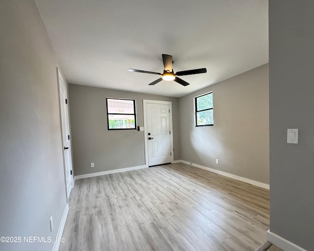 2103 W 14th St, Jacksonville, FL 32209 - spare room featuring light wood finished floors, a ceiling fan, and baseboards