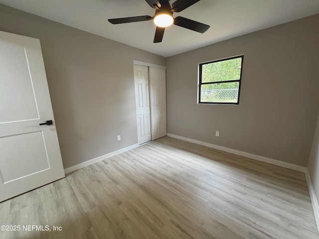 2103 W 14th St, Jacksonville, FL 32209 - unfurnished bedroom with baseboards, light wood-type flooring, a closet, and a ceiling fan