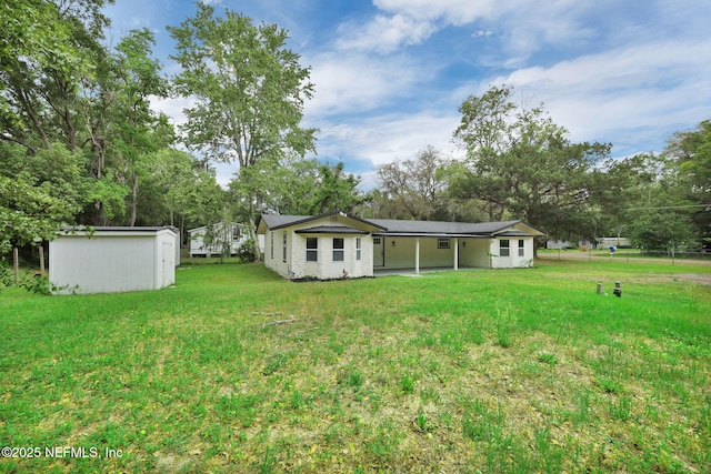 view of yard with a storage unit, an outbuilding, and an attached carport